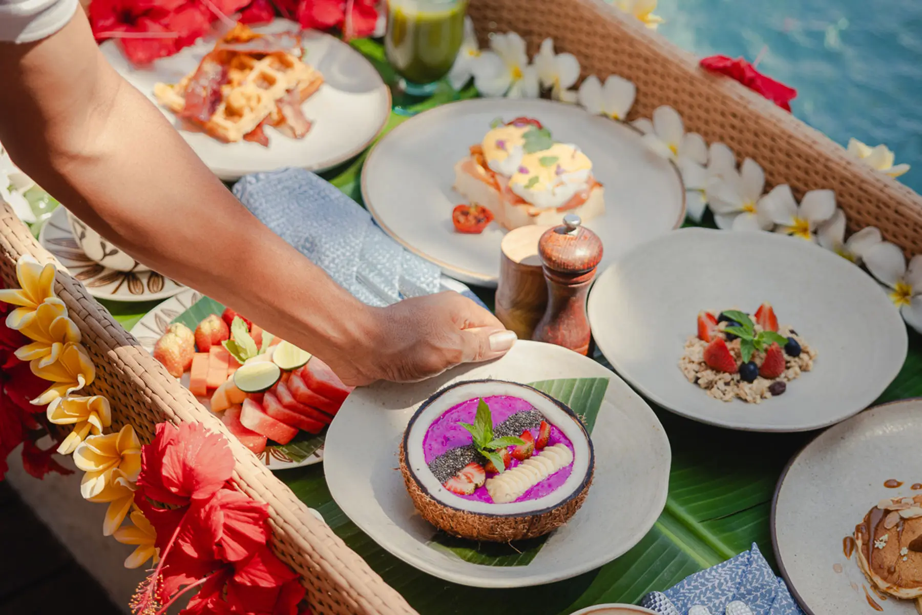 A colorful NIHI Sumba breakfast prepared beside a private pool